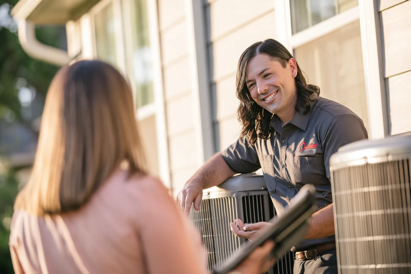 Technician repairing a home air conditioner paid for with a personal loan